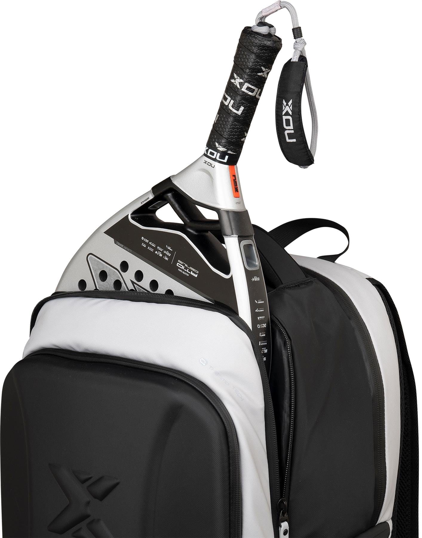 A close-up of a black and white padel racket partly inside the NOX Luxury Master Series Padel Backpack - Black / White by NOX, with its handle and wrist strap visible above the zipper.