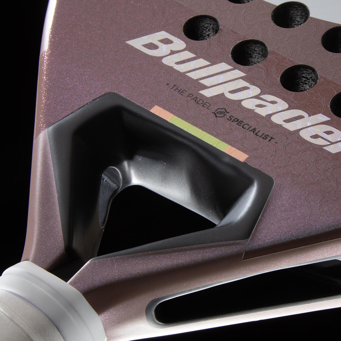 Close-up of the Bullpadel Wonder 2026 Padel Racket - Rose Gold by Bullpadel, highlighting its logo, Hyper Core textured surface, drilled holes near the neck, and a partially visible black and white grip for a premium professional look.
