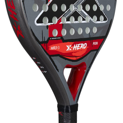 Close-up of the NOX X-Hero Red Padel Racket by NOX—a beginner’s padel racket designed for control and precision, featuring a black and red face with circular holes, a textured grip handle, model "HR3," and bold graphics.