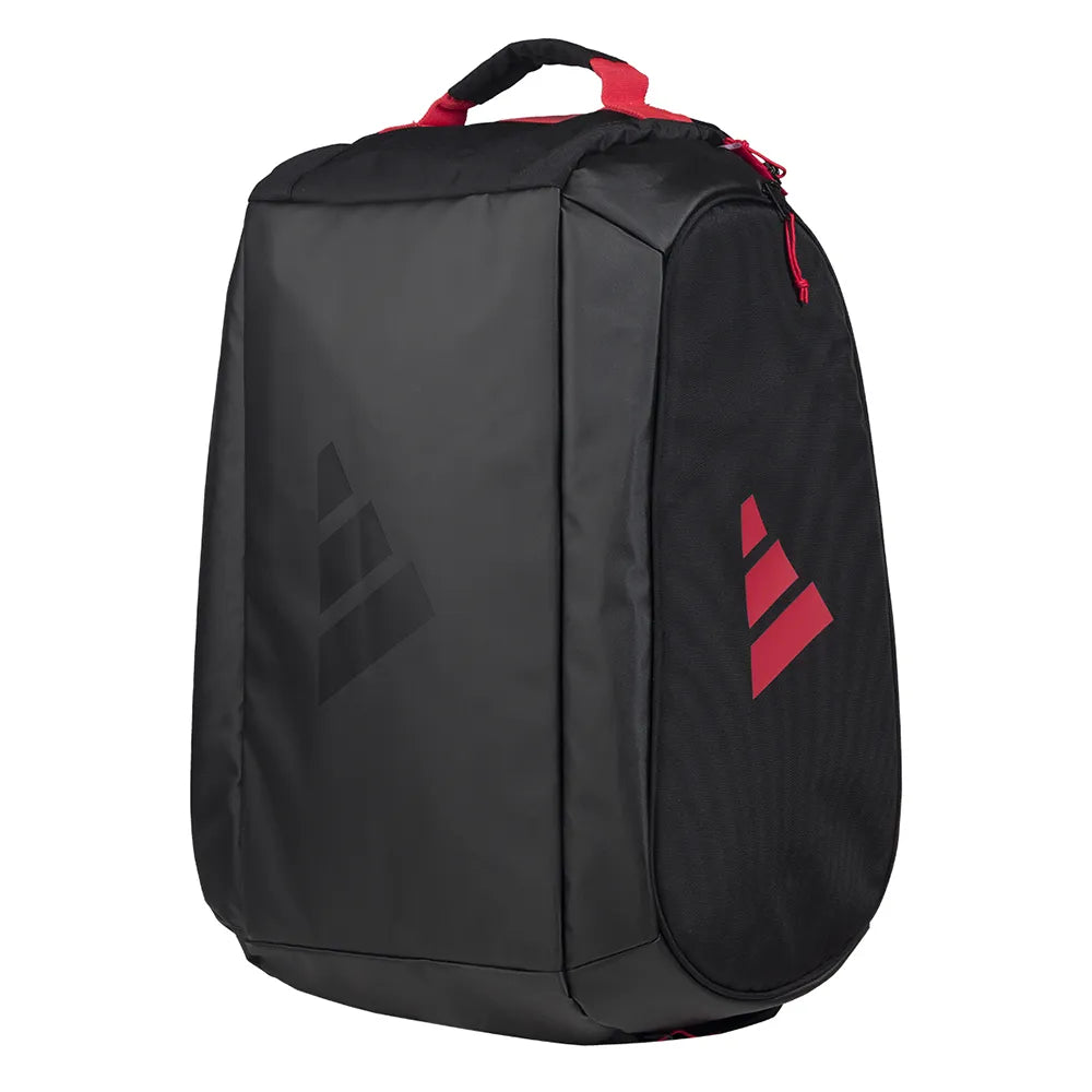 The adidas ADIDAS Tour 3.4 Padel Racket Bag - Black features red accents, a red zipper and handle, thermal insulation, and a black and red geometric logo on its sleek, rectangular shape with rounded edges.
