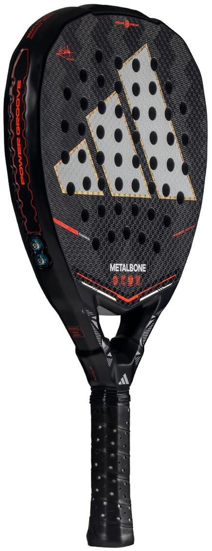 The adidas Metalbone by Ale Galán 2026 Padel Racket in black features a bold silver logo, red accents, a perforated face, and an innovative adjustable weight system, with branding and the handle highlighted at an angle.