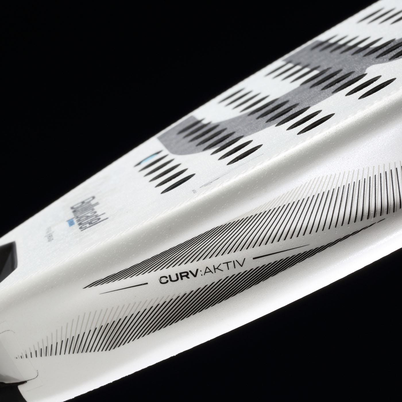 Close-up of the Bullpadel Vertex 05 2026 Padel Racket by Bullpadel in white and black, featuring black and gray geometric patterns and "CURV:AKTIV" text printed on its surface, set against a black background.