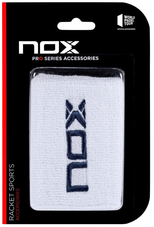 The NOX Padel Wristband - White / Navy Blue offers wrist protection with Balance Fresh tech and features the NOX logo. Packaged in a black/red blister pack marked “NOX Pro Series Accessories” and “World Padel Tour Official Accessories.”.