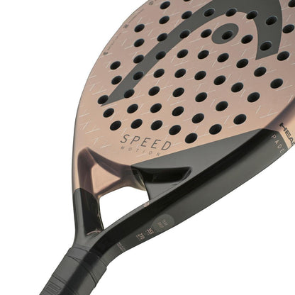 Close-up of the HEAD Speed Motion 2025 Padel Racket in copper and black, showcasing Auxetic 2.0 technology and a perforated surface design. The word "Speed" enhances its powerful performance on the court.