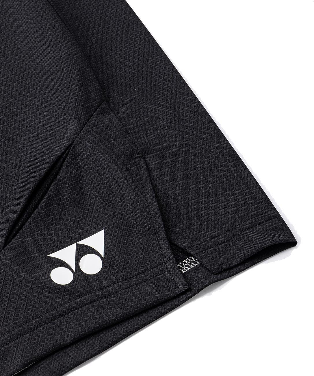 Close-up of Yonex 15239YX Knit Men's Padel Shorts in black, featuring a white Yonex logo near the hem and detailed seams—lightweight athletic shorts designed for top performance on the court.