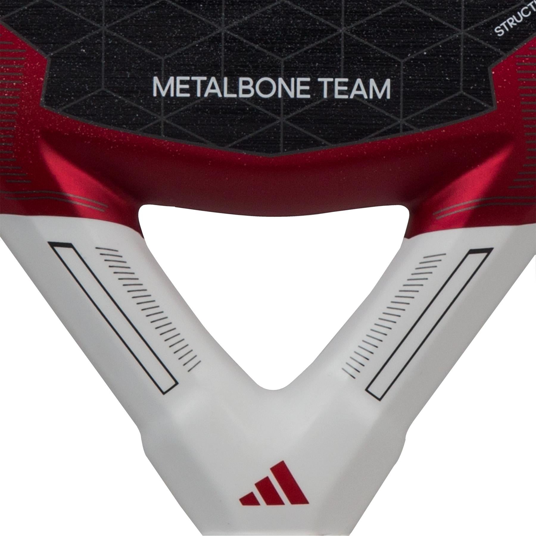 A detailed view of the handle of the ADIDAS Metalbone Team 3.3 Padel Racket - Red showcases a geometric pattern along with "METALBONE TEAM" prominently featured. The red, black, and white color scheme with sleek linear accents and a small emblem at the bottom enhances its performance-focused design, perfectly complementing its diamond-shaped head.