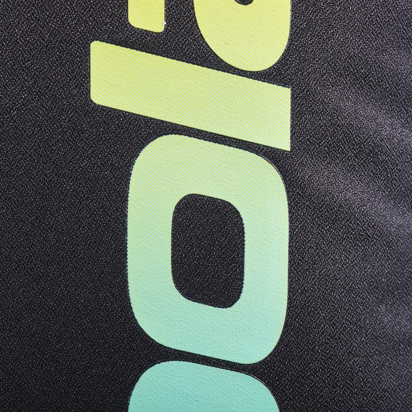 Close-up of the Babolat Court Lite Padel Backpack - Black / Multi, showing textured black fabric and bold yellow-to-blue gradient "90" numbers printed vertically next to the roomy racket compartment.