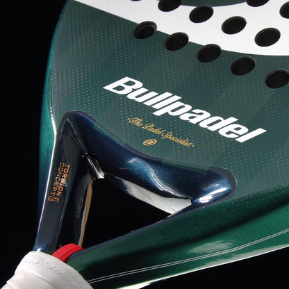 Close-up of a Bullpadel Icon 2026 Padel Racket in green, featuring the Bullpadel brand name and logo, circular holes on the racket face, and a white-gripped handle—favored by professional player Juan Martín Díaz.