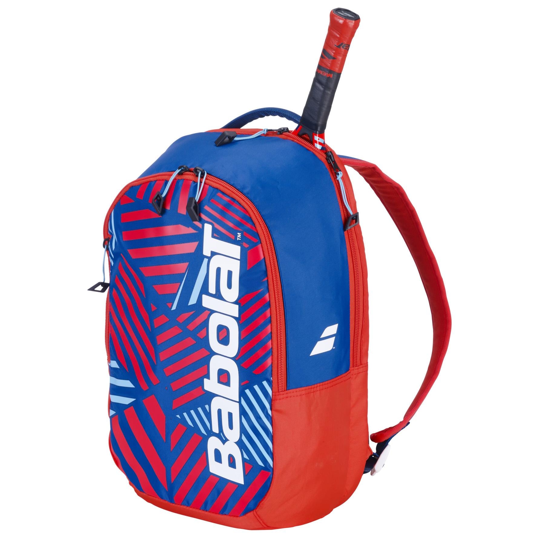 The Babolat Kids Padel Backpack - Blue/Red features a bold blue and red geometric pattern with the brand name in white. Made from recycled materials, it includes adjustable red straps, a zippered front pocket, and can partially fit a tennis racket in the back compartment.