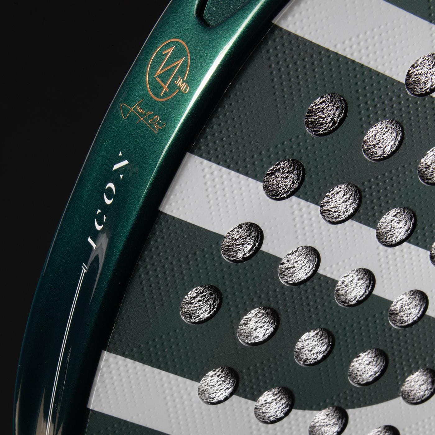 Close-up of the Bullpadel Icon 2026 Padel Racket - Green by Bullpadel, showing a green and white face with textured silver dots, diagonal white stripes, and unique branding details on the frame.