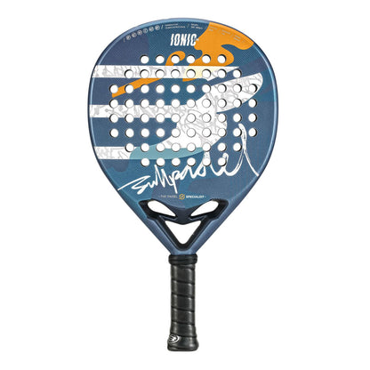 The Bullpadel Ionic Control 25 Padel Racket in blue features a striking design with orange accents, black grip, and a white signature at its core. The innovative XForce system enhances performance, circular holes add geometric flair, and "IONIC" is elegantly printed on top.