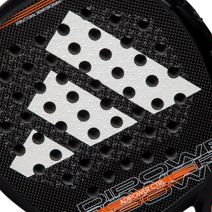 Close-up of the ADIDAS Adipower CTRL 3.3 Padel Racket in black, showcasing its Carbon Fiber 3K construction with a white adidas logo featuring three diagonal stripes. The surface is adorned with perforations and a textured finish, while "ADIPOWER CTRL" is elegantly displayed in orange along the edge.