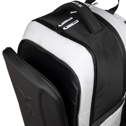 Close-up of the NOX Luxury Master Series Padel Backpack in black and white, featuring multiple zippered compartments—one partially open—showing spacious storage and detailed zipper pulls, perfect for carrying your padel gear.