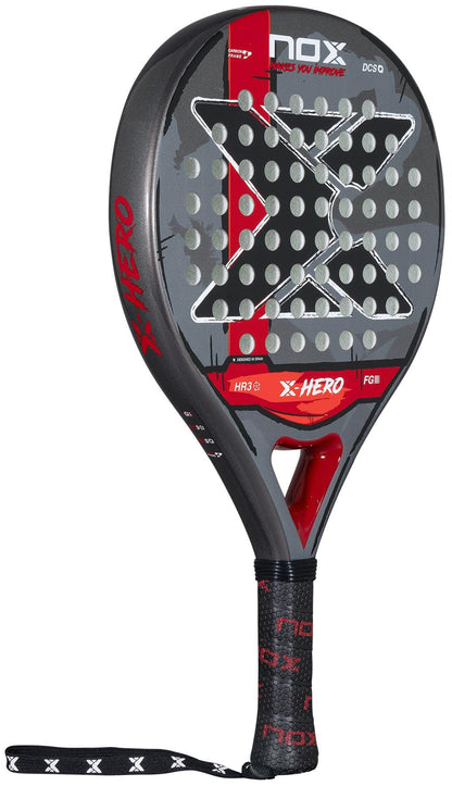 The NOX X-Hero Red Padel Racket by NOX is a beginner-friendly black and red racket featuring a large "X" on the face, round holes for control, the model name above the handle, and a black grip with red and white accents.