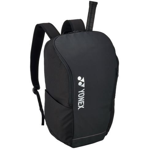 The Yonex 42312SEX Team Padel Backpack - Black features padded shoulder straps and a dedicated space for a tennis racket handle. The Yonex logo is prominently displayed on the front, making it perfect for fans of racket sports.