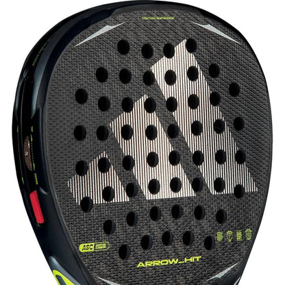 Close-up of the adidas Arrow Hit 2026 Padel Racket, showing a bold white adidas logo, intelligent balance system, round holes, and yellow “ARROW-HIT” text on the lower section—crafted for outstanding power in padel play.