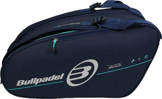 The Bullpadel BPP26015 Tour 2026 Padel Racket Bag in navy features two straps, a zipper, thermal racket compartments, and the Bullpadel logo with "The Padel Specialist" on the side—ideal for any padel fan.