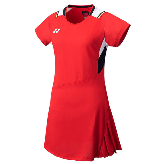 The Yonex 20686 Women's Dress in Ruby Red showcases short sleeves and features white and black accents near the shoulders. It offers the added comfort of VERY COOL TECHNOLOGY and displays a brand logo on the chest. With a pleated design on the lower right side and UV REDUCTION, it's ideal for outdoor activities.