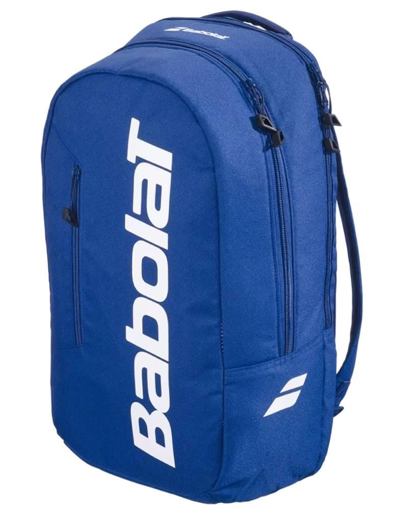 The Babolat Court Lite Padel Backpack in dark blue features white logo lettering and two zippered compartments, including a dedicated racket space. Shown angled on a plain background.