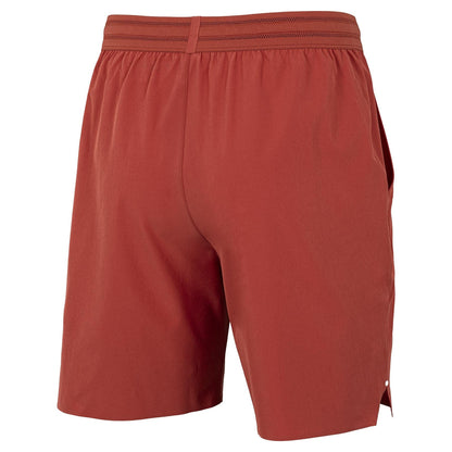 The Tecnifibre Team Stretch Men's Padel Shorts in terracotta feature a minimalist design with an elastic waistband, side seams, and comfortable stretch fabric, shown here from the back.