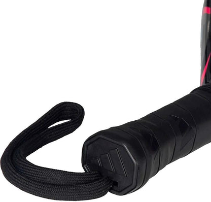 Close-up of a black textured handle with wrist strap on the adidas Arrow Hit Junior White / Pink padel racket, set against a white background.