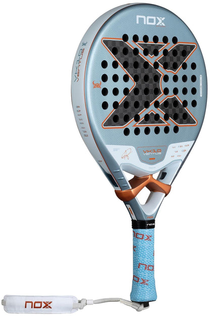 The NOX Luxury VK10 Ventus Control 12K By Aranzazu Osoro 2026 Padel Racket features a light blue face, black X design, orange accents, perforated surface, white wrist strap, and textured blue NOX-branded grip with a 12K carbon finish.