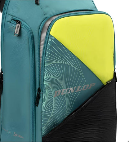 Close-up of the Dunlop SX Performance Padel Backpack in teal, black, and yellow, featuring a side pocket with a yellow and gray patterned item. The backpack has a visible zipper and sleek design, ideal for serious players.