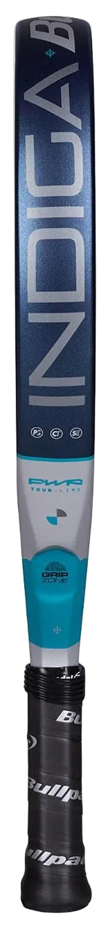 A close-up of the Bullpadel Indiga Pwr 2026 padel racket in blue, silver, and black features "Bullpadel" and "INDIGA" on the head. The black grip displays the Bullpadel logo, highlighting this power racket’s modern design.