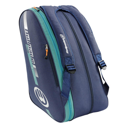 The Bullpadel Tour 25 Padel Racket Bag in navy boasts prominent Bullpadel branding with orange and teal graphics. It includes multiple compartments, a padded racket section, adjustable straps, and a padded handle for comfortable carrying.