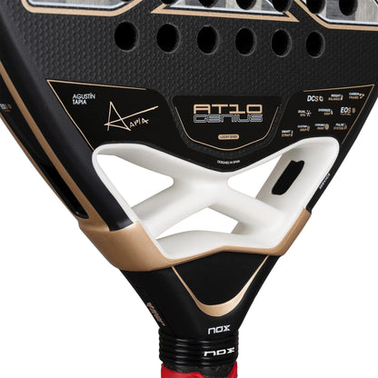 Close-up of the black NOX AT10 Genius 18K Alum By Agustín Tapia 2026 Padel Racket, showcasing gold accents, signature details, a unique triangular cutout, and an advanced Dual Spin surface for superior control and spin.