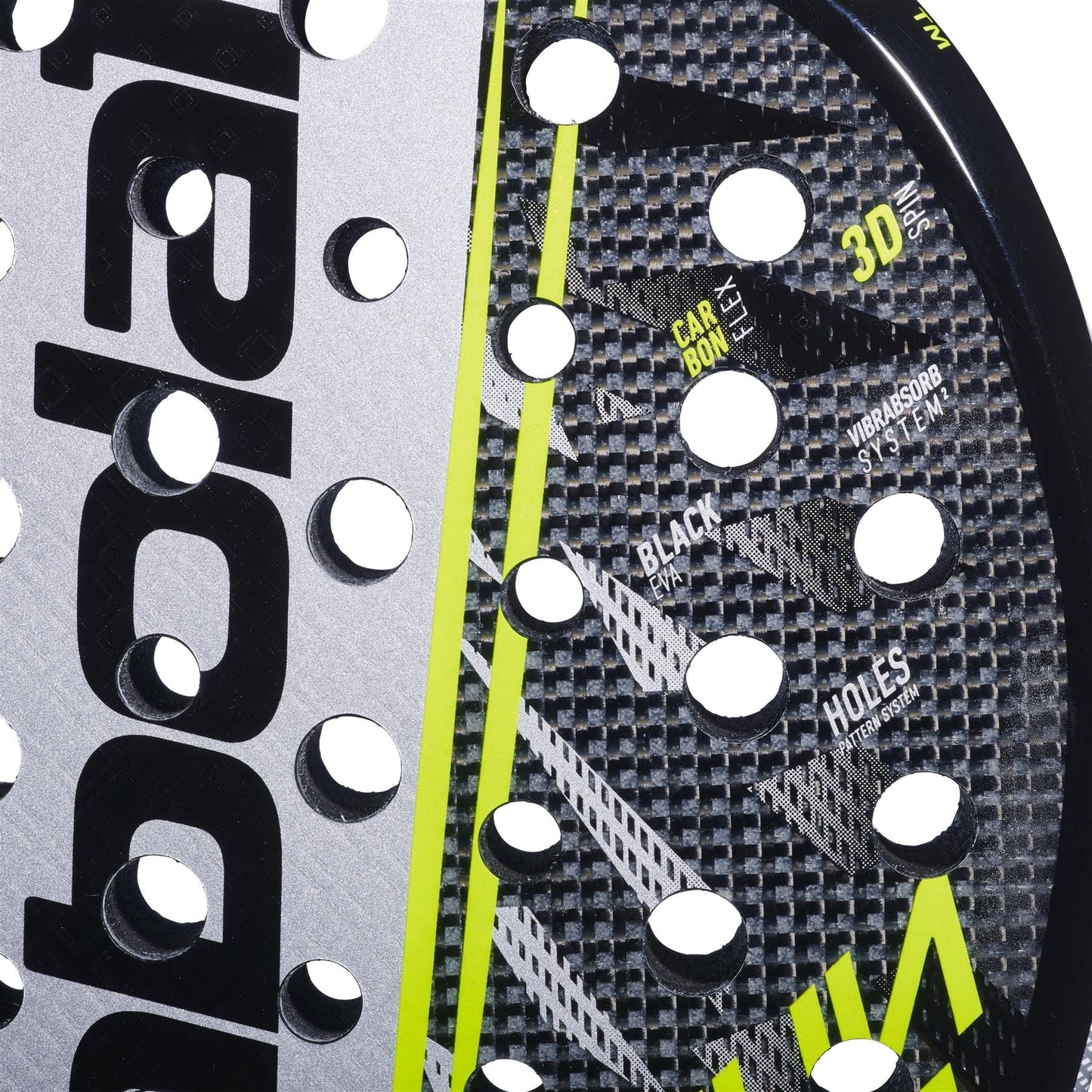 Close-up of the Babolat Counter Veron 2.6 Padel Racket in black and gray with CarbonFlex construction, round holes, yellow accents, and visible Babolat branding and technical details on the surface.