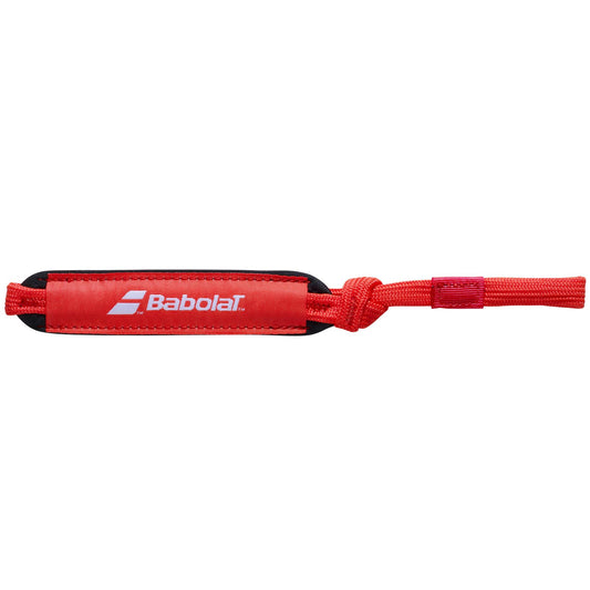 The Babolat Padel Wrist Strap in red, featuring white text, is designed as a removable wrist strap for added convenience.