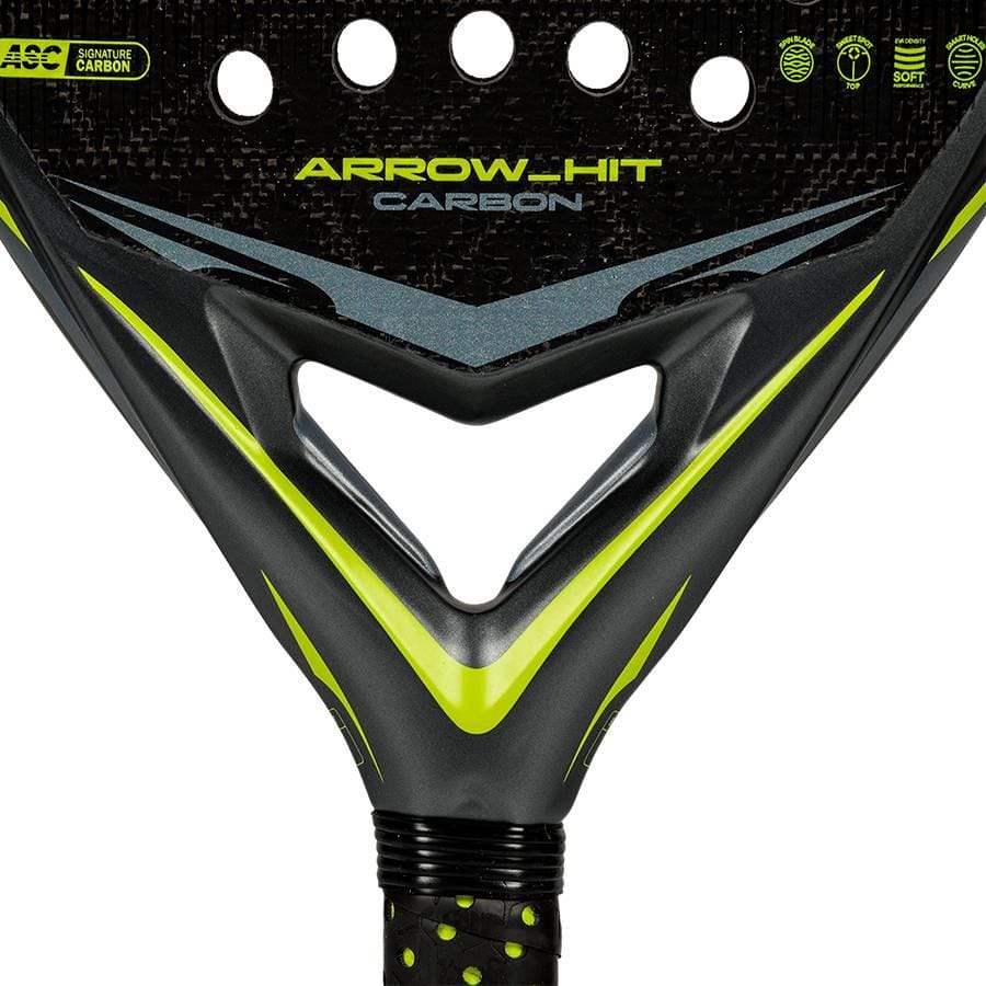Close-up of the adidas ADIDAS Arrow Hit Carbon 2026 Padel Racket, featuring a black and yellow design, triangular throat, grip tape handle, and circular holes on its carbon face.