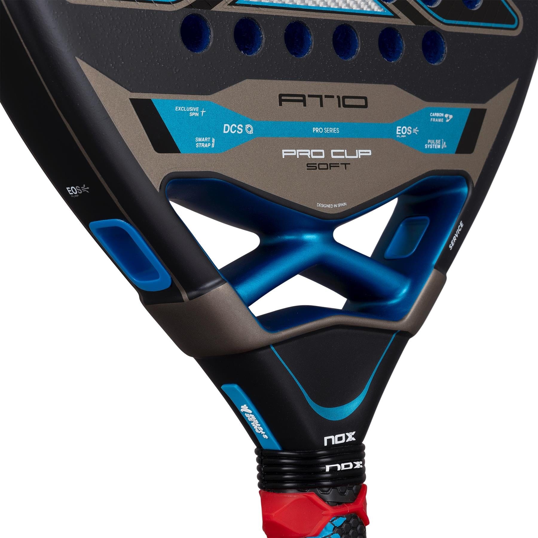 Close-up of the NOX AT10 Pro Cup Soft By Agustín Tapia 2026 padel racket, showcasing its black and blue design, textured surface, brand logos, and technical details near the handle.