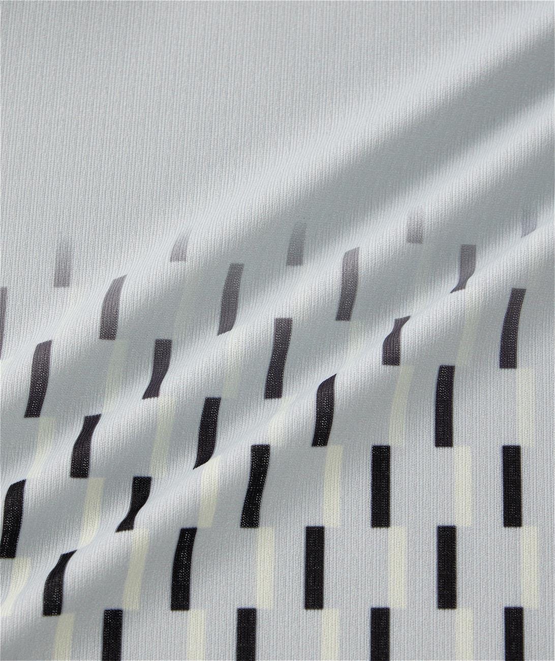 A silver grey Yonex 10713EX crew neck men's padel T-shirt features a diagonal drape and a pattern of black and off-white vertical rectangular shapes in staggered rows.