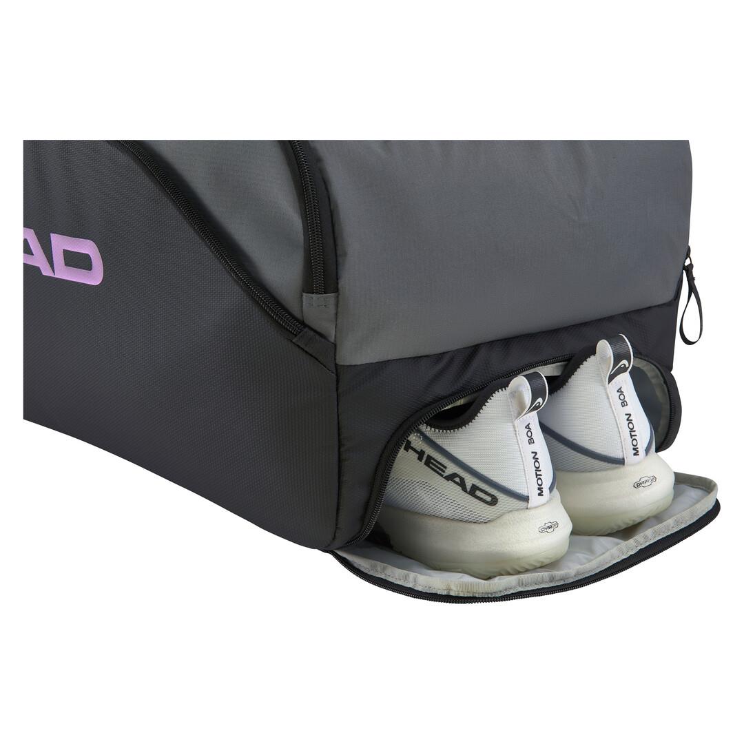 A pair of white sneakers made from recycled materials peeks out of a HEAD Pro X Duffle Padel Bag L in black/dark grey, blending style with eco-friendly design.