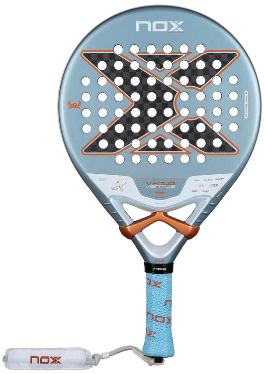 The NOX Luxury VK10 Ventus Control 12K By Aranzazu Osoro 2026 padel racket features a light blue design, large black "X," orange details, 12K carbon construction, perforated surface, and a padded blue grip with white wrist strap.