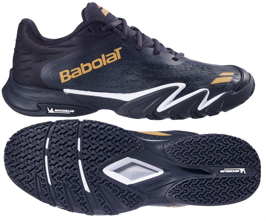 The Babolat Premura 3 Mens Padel Shoes in black and gold feature bold branding, a textured rubber sole, and a standout white zigzag design along the side, shown from both side and bottom views.