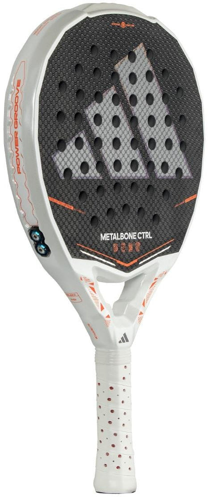 The adidas Metalbone Ctrl 2026 Padel Racket - Black features orange accents, perforated holes, a large adidas logo, “METALBONE CTRL” on the face, and an adjustable weight system for personalized play.