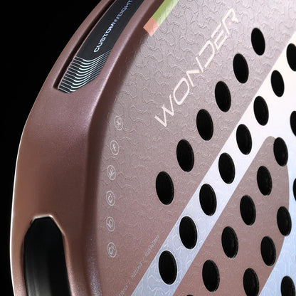 Close-up of the Bullpadel Wonder 2026 Padel Racket in rose gold, featuring a textured surface, Hyper Core technology, black circular holes, "WONDER" branding, edge logo, and a custom weight system for pro-level play.