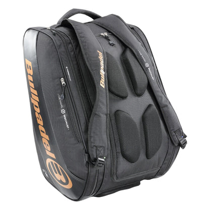 The Bullpadel Vertex 25 Padel Racket Bag in black features padded shoulder straps, multiple zippered compartments, and a ventilated section for sports gear, with orange Bullpadel branding on the side to match your Vertex Padel Racket.