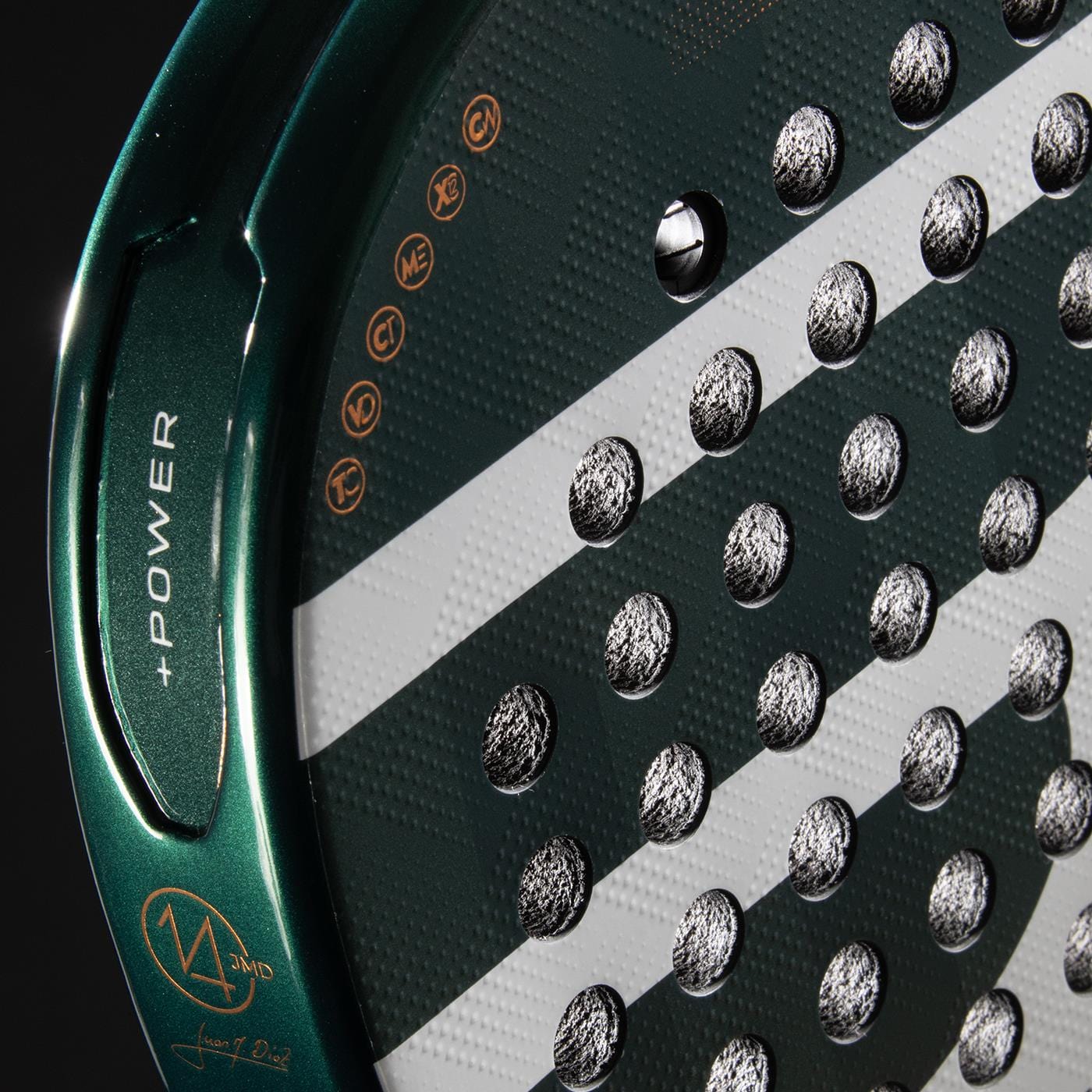 Close-up of the Bullpadel Icon 2026 Padel Racket - Green, showing its green and black face with round holes, white diagonal stripes, gold "POWER" on the edge, and a Juan Martín Díaz signature. Brand: Bullpadel.