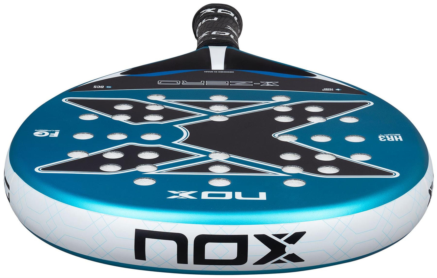 A close-up of the NOX X-Zero Blue Padel Racket by NOX, a beginner model in blue and black with a large "X" design, multiple circular holes for control, and a black grip-wrapped handle.