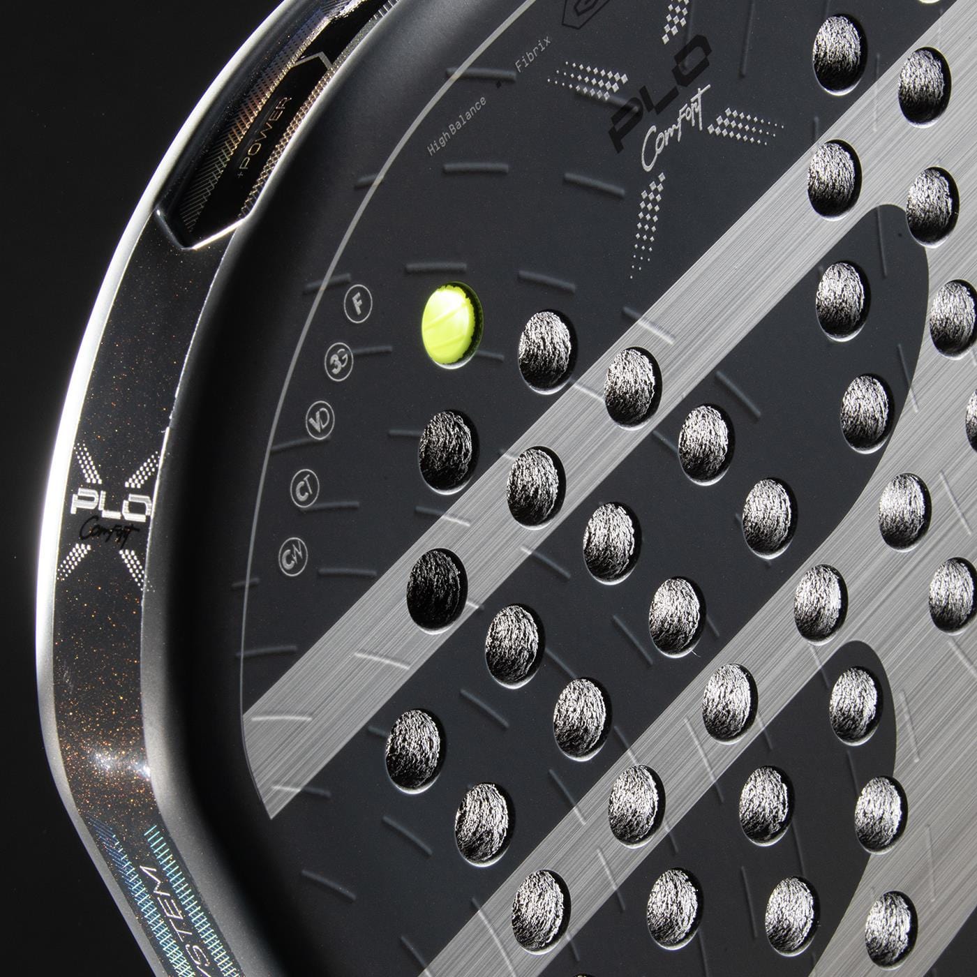 Close-up of the Bullpadel XPLO Comfort 2026 Padel Racket - Grey with circular holes, white graphics, and a textured surface, plus a yellow padel ball behind it. Designed by Bullpadel for exceptional comfort on court.