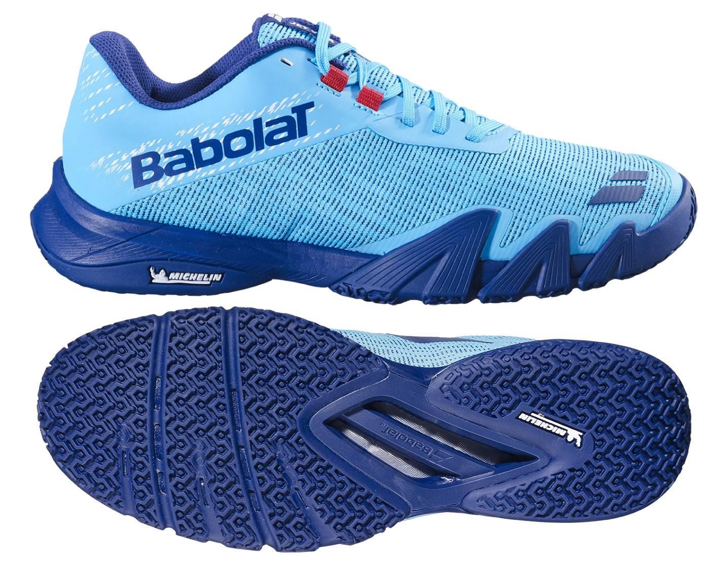 The Babolat Jet Viva Mens Padel Shoes in Scuba Blue are shown from the side and bottom, featuring a textured Michelin sole, mesh upper, and bold Babolat lettering—perfect for intermediate padel players.