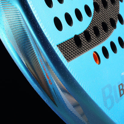Close-up of the Bullpadel Vertex 05 W 2026 Padel Racket by Bullpadel, featuring black circular holes, a textured blue and black surface, and "CURVAKTIV®" in red on the rim against a black background.