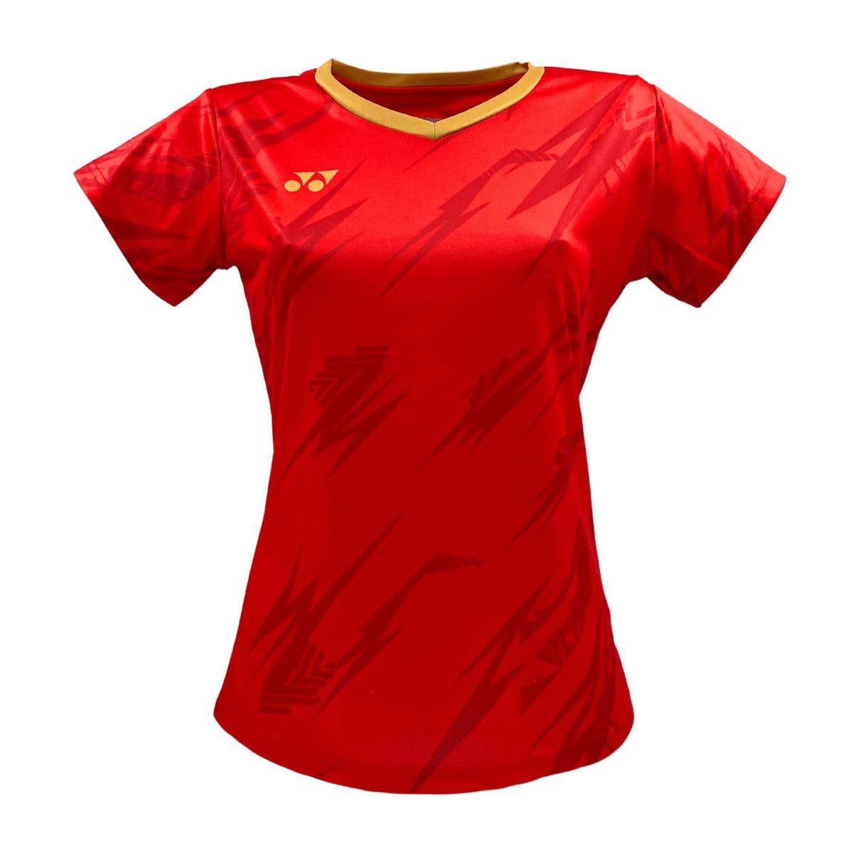 The Yonex YTL8 Women's Padel T-Shirt is a red sports jersey with short sleeves and a zigzag pattern, featuring a small two-circle-and-triangle logo on the left chest, gold-trimmed round neckline, and performance-oriented moisture-wicking polyester.