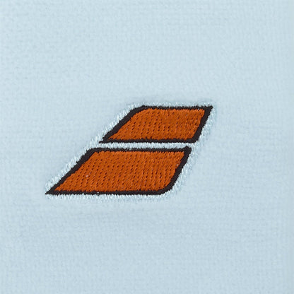 Two orange parallelograms outlined in black, stacked with a slim gap, echo the bold style of the Babolat Terry Jumbo Wristband - Illusion Blue against a light blue textured background.