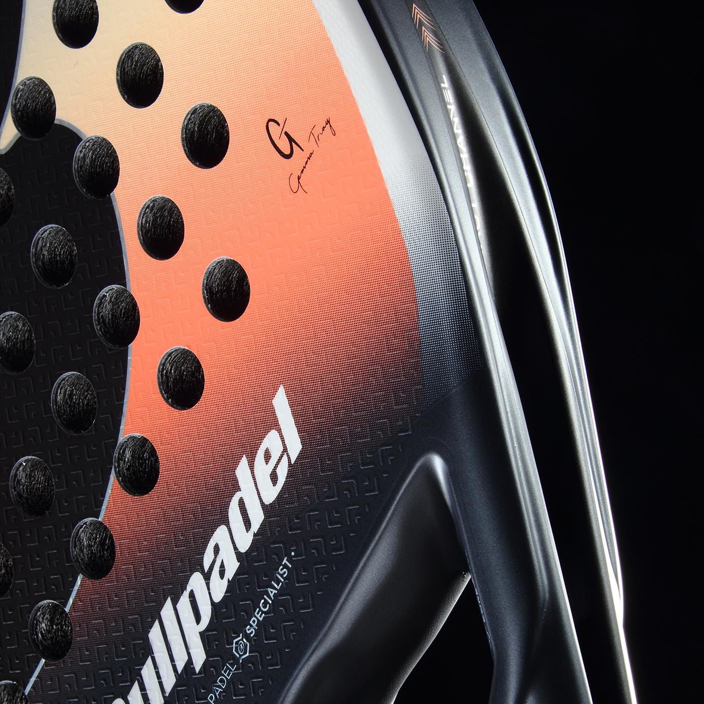 Close-up of the Bullpadel Elite W 2026 Padel Racket by Bullpadel, a lightweight, high-performance padel racket in black and white with textured holes and signature branding, shown against a dark background.