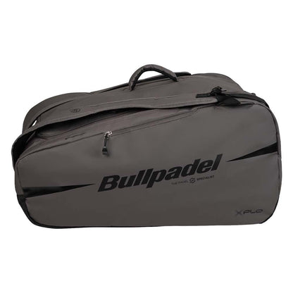 The Bullpadel BPP26022 XPLO Padel Racket Bag in grey features black zippers, handles, bold "Bullpadel" branding on the side, thermal racket compartments, and "XPLO" printed in the lower right corner.